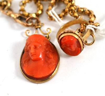 Lot 25 - A coral set ring and a coral pendant carved with a maiden, on chain
