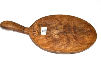 Lot 63 - A Robert 'Mouseman' Thompson oak cheese board, with carved mouse signature on the board...