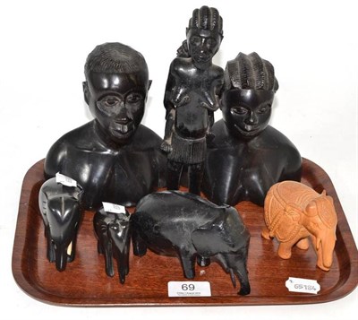 Lot 69 - Seven African figures including four elephants, a pair of busts and a lady carrying a baby on...