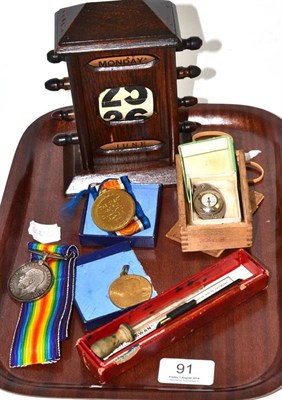 Lot 91 - Adjustable calendar, Swan fountain pen, small compass, two war medals and a coronation medal