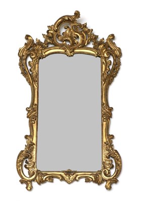 Lot 973 - A Louis XV Style Carved Giltwood Mirror, 19th century, the bevelled glass plate within an...