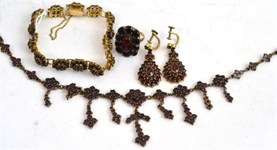 Lot 119 - A garnet set necklace, bracelet and earring set and a ring