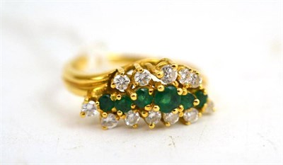 Lot 123 - An emerald and diamond three row ring