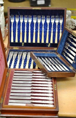 Lot 163 - A cased set of twelve ivory and silver plated fish knives and forks, a set of six cake knives...