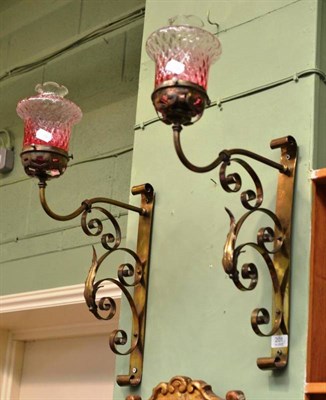 Lot 201 - Pair of Arts & Crafts wall lights with cranberry shades