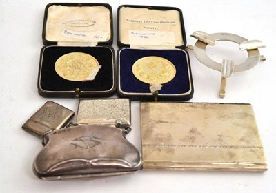 Lot 267 - A silver cigarette case, purse, two vesta cases, an ashtray and two cased medallions