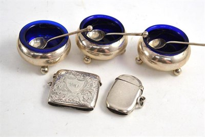 Lot 328 - A set of three Victorian silver salts and spoons and two silver vesta cases