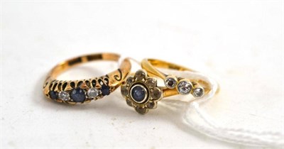 Lot 382 - A diamond and sapphire five stone ring stamped '18C', 18ct gold three stone ring and a sapphire and