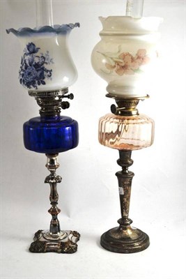 Lot 387 - Two silver plated oil lamps one with a blue glass font