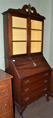 Lot 487 - Small mahogany bureau bookcase with key