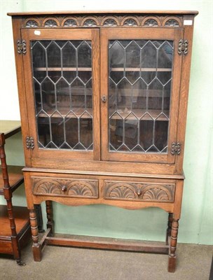 Lot 492 - A reproduction bookcase with glazed cabinet doors