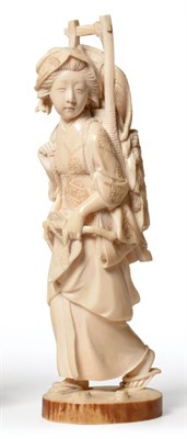 Lot 166 - A Japanese Ivory Okimono, Meiji period, as a girl in flowing robes carrying a basketwork panier, on