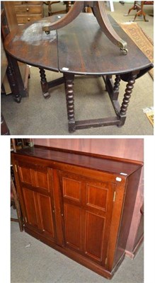 Lot 516 - Oak drop leaf oval table and a mahogany cupboard