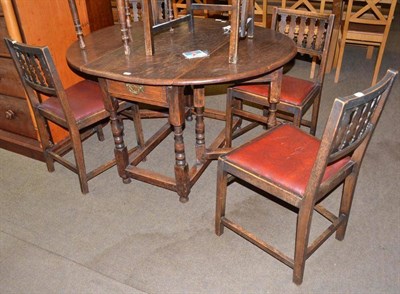 Lot 517 - An oak gate leg table, five chairs and a piano stool