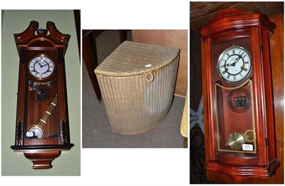 Lot 525 - Two modern striking wall clocks and a Lloyd Loom laundry basket