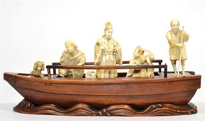 Lot 173 - A Japanese Ivory and Hardwood Okimono, Meiji period, as a dignitary and two attendant musicians...