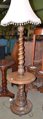 Lot 566 - An oak standard lamp with incorporated table