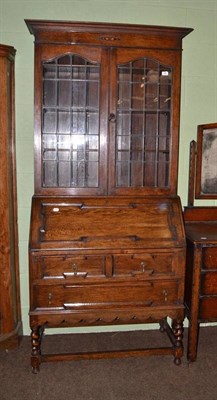 Lot 588 - An ebonised two tier console table with three drawers