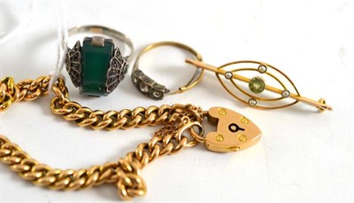 Lot 35 - A peridot and seed pearl brooch, Chester 1911, a curb and lock bracelet and two dress rings