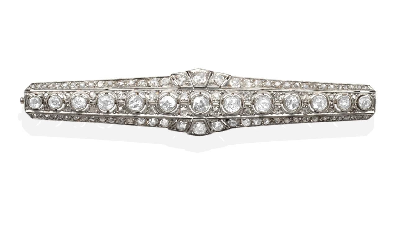 Lot 296 - A Diamond Brooch, a central row of graduated old cut diamonds in milgrain settings, within a...
