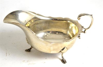 Lot 127 - A silver sauce boat with flying scroll handle, Chester 1908