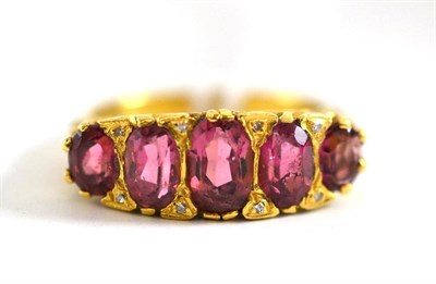 Lot 143 - A Victorian ring, set with five graduated pink tourmalines, with pairs of tiny diamonds between...