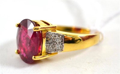 Lot 147 - An 18ct gold 'Royal Ruby' and diamond ring, the oval mixed cut ruby with small diamonds on the...