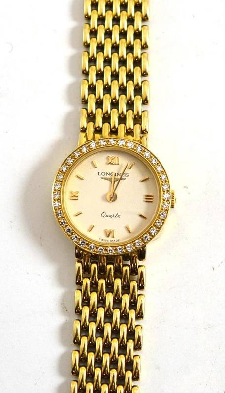 Lot 150 - A Longines 9ct gold watch with diamond set bezel