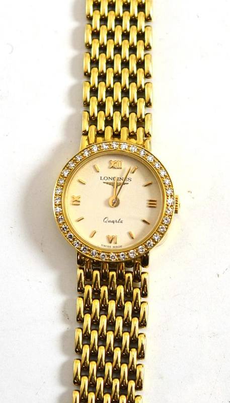 Lot 150 A Longines 9ct gold watch with diamond set