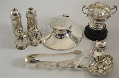 Lot 166 - A silver inkwell, two pairs of pepperettes, a Victorian sifter spoon, a silver trophy cup, two...