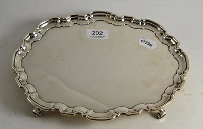 Lot 202 - A shaped oblong silver tray on scrolled feet