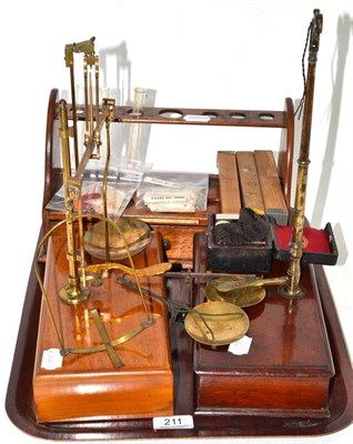 Lot 211 - Two brass beam balances, another cased scales and a test tube rack