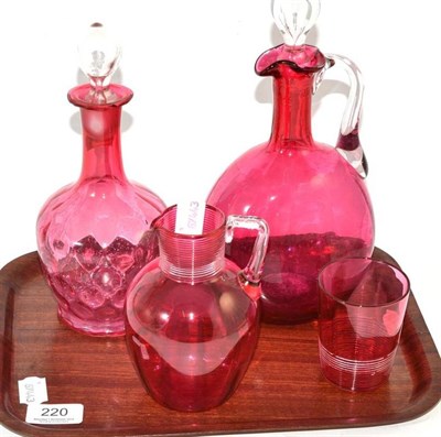 Lot 220 - Two cranberry glass decanters, a jug and glass