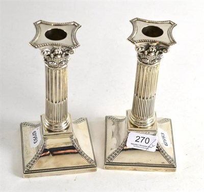 Lot 270 - Pair of silver Corinthian column candlesticks, London hallmark