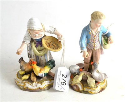 Lot 276 - A pair of late Meissen figures of a girl feeding chickens and boy feeding ducks (a.f.)