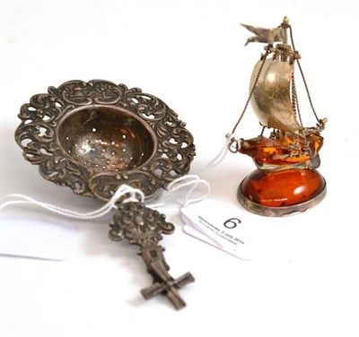 Lot 6 - Dutch silver strainer and a small silver amber mounted ship