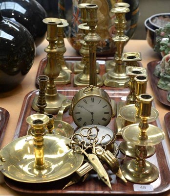 Lot 48 - Two trays of brassware including assorted candlesticks, candle snuffers, timepiece etc