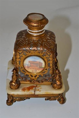 Lot 106 - 19th century gilt metal scent bottle decorated with landscapes raised on a onyx stand (a.f.)