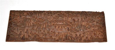 Lot 109 - A Cantonese carved wooden panel depicting figures walking and trading amongst pagodas