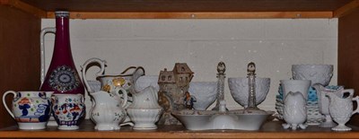 Lot 128 - A shelf containing a quantity of pressed glass, 19th century ceramic jugs etc