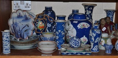 Lot 140 - A shelf of Oriental ceramics, including a large powder blue ground ginger jar and cover, vases,...