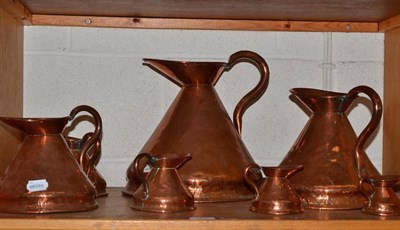 Lot 153 - Seven graduated copper jugs