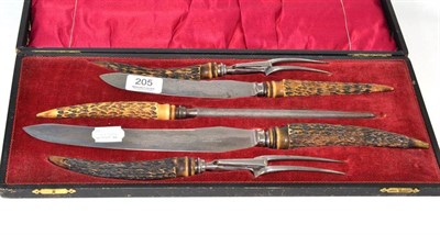 Lot 205 - A carving set in fitted case with horn handles and Dickinson of Sheffield blades