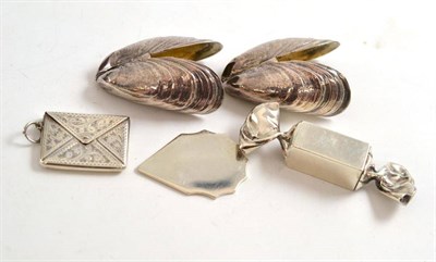 Lot 210 - Two white metal 'mussel' shaped mussel grabbers, a silver walnut opener, a sweet pill box and a...