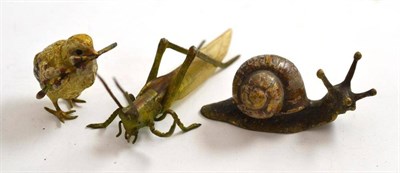 Lot 219 - Cold painted bronze figure of a snail, another of a bird and another of a locust