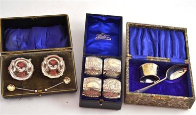 Lot 248 - A set of four silver napkin rings, christening set and a pair of salts, all cased