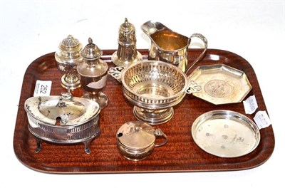 Lot 252 - A collection of assorted silver pepperettes, mustards, a cream jug, strainer, two dishes, etc