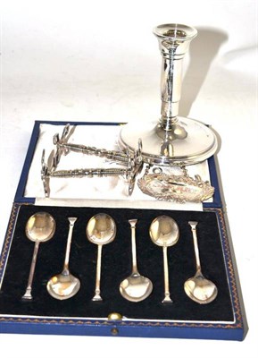 Lot 275 - Six silver coffee spoons, two knife rests, decanter label and a silver dwarf candle stick