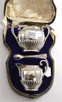 Lot 322 - A Victorian silver presentation milk jug, sugar bowl and tongs, Sheffield 1895 in a velvet...