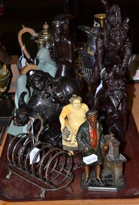 Lot 338 - A spelter strike light in the form of a man near a back press, carved hardwood figure stamped BALI